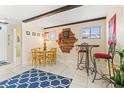 Cozy dining area featuring rustic beams and a unique decorative dart board at 251 Dunbridge Dr, Palm Harbor, FL 34684