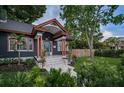 Beautiful home showcasing a well-maintained lawn, garden, and charming front porch with copper pillars at 2536 Burlington N Ave, St Petersburg, FL 33713