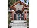 Inviting home with a striking blue door, elegant copper accents, and manicured front yard landscaping at 2536 Burlington N Ave, St Petersburg, FL 33713