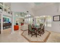 Bright dining area featuring high ceilings, expansive windows, and seamless flow into the living room at 2613 59Th S St, Gulfport, FL 33707