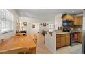 Open kitchen featuring granite counters, warm wood cabinets and stainless steel appliances at 2903 W Paxton Ave, Tampa, FL 33611