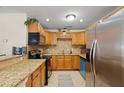 Well-equipped kitchen featuring granite counters, stainless steel appliances, tile backsplash and ample cabinetry at 2903 W Paxton Ave, Tampa, FL 33611