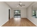 Bright bedroom featuring hardwood flooring, ceiling fan, sliding glass doors and plenty of natural light at 3203 Green Dolphin St, Tarpon Springs, FL 34689