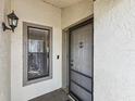Close-up showcasing the front door with decorative anchor and small window, enhancing the home's entrance at 3203 Green Dolphin St, Tarpon Springs, FL 34689