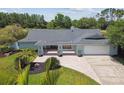 Beautiful single-story home boasts lush landscaping, a brick driveway, and a spacious two-car garage at 4106 Queller Way, Tampa, FL 33618