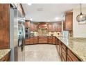 Gourmet kitchen with stainless steel appliances, granite countertops, custom cabinets, and mosaic backsplash at 4106 Queller Way, Tampa, FL 33618