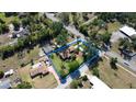 Overhead view of house and lot, nestled amidst lush trees in a quiet community at 4801 Lynn Oaks Cir, Dover, FL 33527