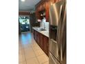 Updated kitchen featuring a stainless steel refrigerator and a sink with granite countertops at 6190 80Th N St # 204, St Petersburg, FL 33709