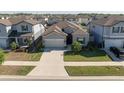 Aerial view showcases this house, surrounded by greenery, in a neighborhood with similar homes at 10303 Malvasia Ave, Riverview, FL 33578
