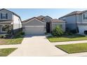 Beautiful home exterior featuring a lush front lawn, two-car garage, and elegant gray color at 10303 Malvasia Ave, Riverview, FL 33578