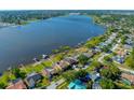 A scenic aerial view of homes along the waterfront, showcasing access to a beautiful lake and surrounding nature at 10833 96Th N St, Largo, FL 33773