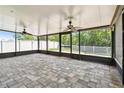 Spacious screened in porch with ceiling fans and exterior backyard view at 11506 Mansfield Point Dr, Riverview, FL 33569