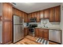 Efficient kitchen features stainless steel appliances, wood cabinets, and functional layout at 1253 Union St, Clearwater, FL 33755
