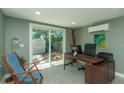 A modern office with sliding glass doors leading to a backyard at 1253 Union St, Clearwater, FL 33755