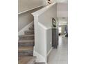 Carpeted staircase featuring white trim and grey walls, leading to the upper level of the home at 12775 Maple Bonsai Dr, Riverview, FL 33579
