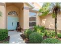 Inviting front entrance with a light blue door, neat landscaping, and a welcoming bench for guests at 1285 Salt Lake Dr, Tarpon Springs, FL 34689