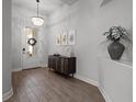 Elegant foyer featuring wood-look tile flooring, decorative lighting, and stylish decor at 15329 Renaissance Ave, Odessa, FL 33556