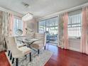 Bright dining room featuring a chandelier, large windows, and access to a patio at 16819 Stanza Ct, Tampa, FL 33624