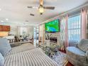 Living room with fireplace, flat screen, hardwood floors, and an open floor plan at 16819 Stanza Ct, Tampa, FL 33624