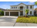 Charming two-story home with a well-manicured lawn and a spacious three-car garage at 17917 Machair Ln, Land O Lakes, FL 34638