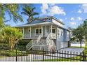 Lovely two-story home with porch and a fenced yard, perfect for enjoying the serene surroundings at 2314 N Riverside Dr, Tampa, FL 33602