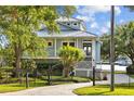 Charming coastal home with a metal roof, covered porch, fenced yard, and waterfront access at 2314 N Riverside Dr, Tampa, FL 33602