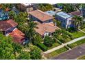 Home featuring a terracotta tile roof, mature landscaping, and a sidewalk at 2421 Brevard Ne Rd, St Petersburg, FL 33704