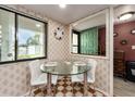 Cozy breakfast nook with tile flooring, modern furnishings and a view of the entryway and outdoors at 2555 Royal Pines Cir # A, Clearwater, FL 33763