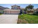 Attractive two-story house boasting a lush green lawn and a spacious three-car garage at 2629 Timacqua Dr, Holiday, FL 34691