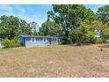 Charming single-story home featuring a cozy front porch, well-shaded by mature trees and natural landscaping at 2805 Olavet Ct, Valrico, FL 33596