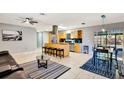 Open-concept kitchen featuring an island with bar seating, stainless appliances, and seamless flow into the living area at 3044 Golden Rain Dr, Sarasota, FL 34232
