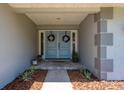 Charming entryway with double doors, decorative wreaths, and stylish tiled floor at 3241 Brushwood Ct, Clearwater, FL 33761