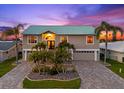 A two-story home with lush palms and a two-car garage, offering waterfront living at its finest at 3505 Seaway Dr, New Port Richey, FL 34652