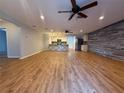 Spacious open concept living room and kitchen with accent wall and vinyl floors at 40709 Melrose Ave, Zephyrhills, FL 33540