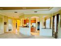 Open-concept kitchen with wood cabinetry and views to the living spaces at 446 Noble Faire Dr, Sun City Center, FL 33573