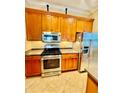 A spacious kitchen featuring stainless steel appliances and wooden cabinets at 446 Noble Faire Dr, Sun City Center, FL 33573
