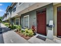 View of townhomes featuring neat landscaping and concrete walkways leading to the front door at 5864 Nature Terrace Cv, Tampa, FL 33617