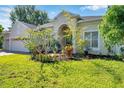 Beautiful home showcasing lush landscaping and healthy green lawn with a bright blue sky at 6130 Japonica Ct, New Port Richey, FL 34655