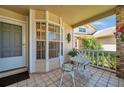 Inviting front porch with a decorative bistro set, perfect for enjoying quiet mornings at 6428 Remus Dr, New Port Richey, FL 34653