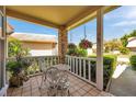 Charming front porch featuring outdoor seating, hanging floral arrangements, and tiled flooring at 6428 Remus Dr, New Port Richey, FL 34653