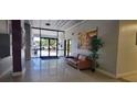 A lobby with tile floors, an art piece, and a seating area near the entrance at 701 S Madison Ave # 316, Clearwater, FL 33756
