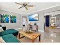 Inviting living room with stylish decor, featuring a comfortable green sofa and modern entertainment center at 7800 Causeway N Blvd, St Petersburg, FL 33707
