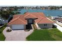 Beautiful home with a well-manicured lawn, a brick driveway and a two-car garage at 8053 13Th S Ave, St Petersburg, FL 33707