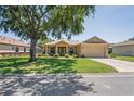 Lovely single-story home featuring manicured lawn, mature tree, and a two-car garage at 9398 N Burnam Dr, Weeki Wachee, FL 34613