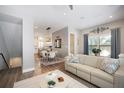 Inviting living room with neutral tones, hardwood floors, and open concept to the dining area at 946 Highland Ave # 47, Dunedin, FL 34698