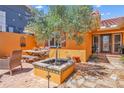 Charming courtyard with flagstone and brick pavers, an Olive tree, and an outdoor dining set at 1008 Mandalay Ave, Clearwater, FL 33767