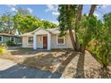 Charming bungalow featuring a well-kept front yard and inviting entryway at 1219 Michigan N Dr, Dunedin, FL 34698