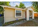 Side view of a cozy bungalow with an ADT security sign and inviting facade at 1219 Michigan N Dr, Dunedin, FL 34698