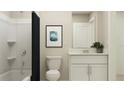 Well-lit bathroom with a shower-tub combo and vanity with clean, modern finishes at 13527 White Gold Run, Parrish, FL 34219