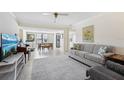 Spacious living room with neutral tones, tile floors, and ample natural light at 13602 Frigate Ct # N201, Clearwater, FL 33762